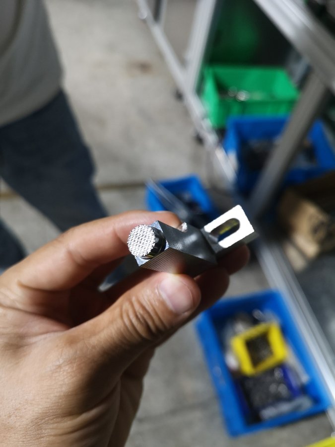 Close inspection of a precision-machined part during a Hengyi factory visit